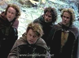 Frodo, Sam, Merry and Pippin look up in fear at the Nazgul on Weathertop.